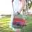Green crossbody bag with colorful tassels
