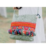 Green crossbody bag with colorful tassels