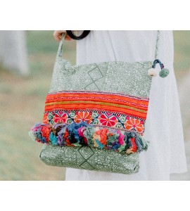 Green crossbody bag with colorful tassels