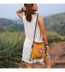 Yellow messenger bag with colorful pompom trim