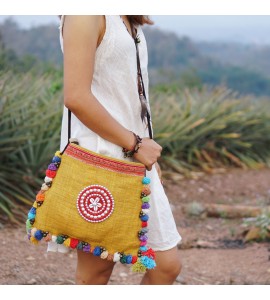 Yellow messenger bag with colorful pompom trim
