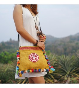 Yellow messenger bag with colorful pompom trim