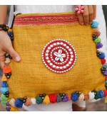 Yellow messenger bag with colorful pompom trim