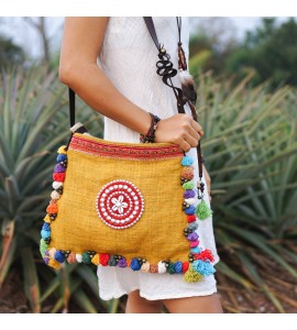 Yellow messenger bag with colorful pompom trim